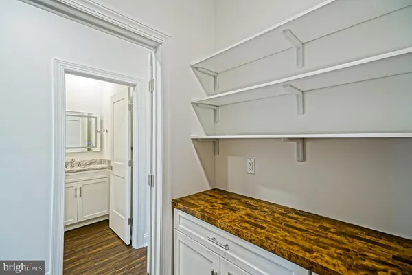 a view of a room with wooden floor