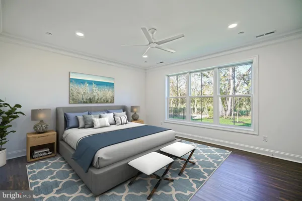 an empty room with wooden floor chandelier fan and windows