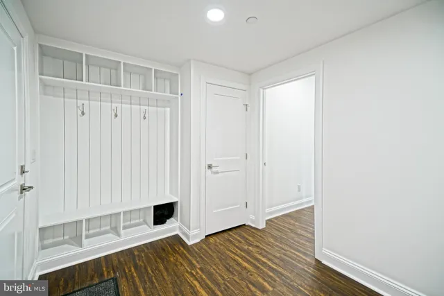 a view of a room with wooden floor and white walls