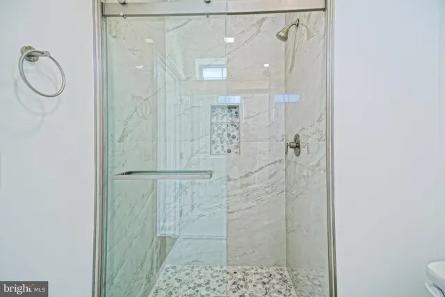a bathroom with a shower and a sink