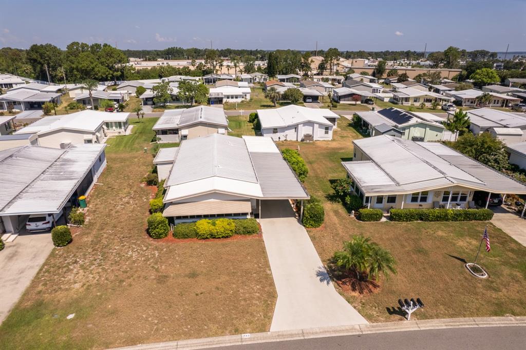 1543 Apache Circle Tavares, FL 32778 - Photo 14 of 19 an aerial view of a house with a yard and lake view