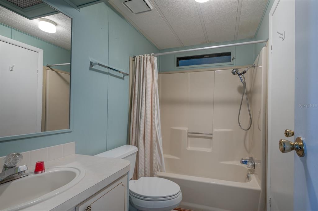 1543 Apache Circle Tavares, FL 32778 - Photo 9 of 19 a bathroom with a sink toilet and shower