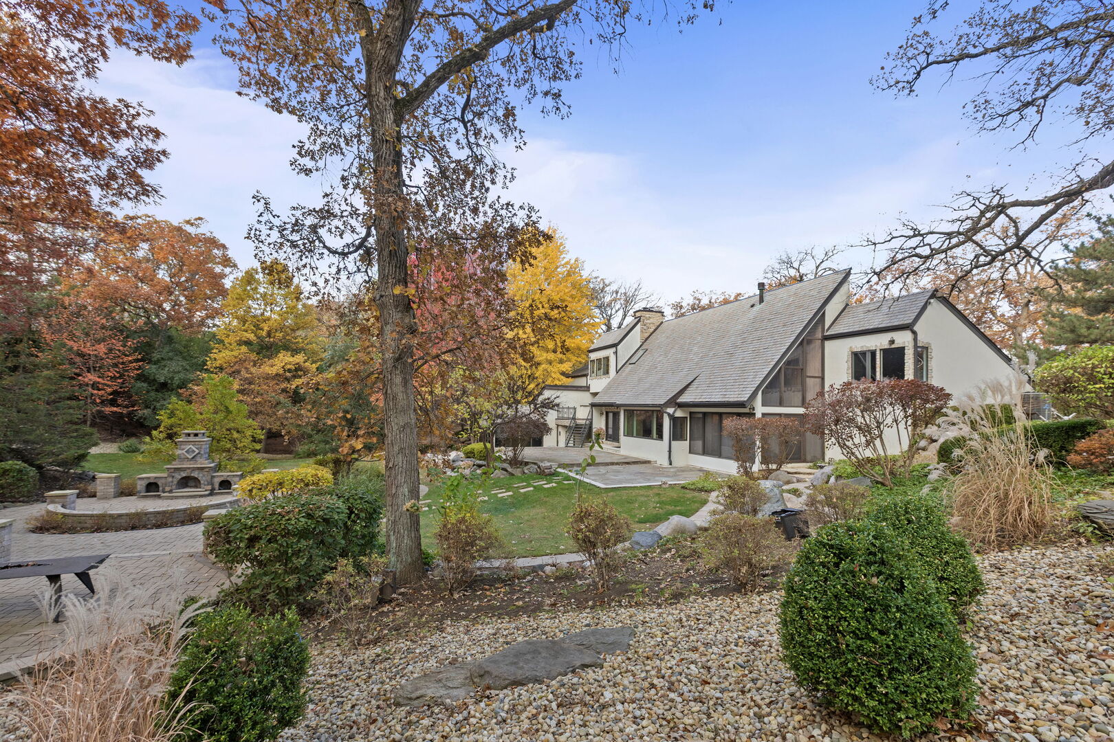 a aerial view of a house with a yard and lake view