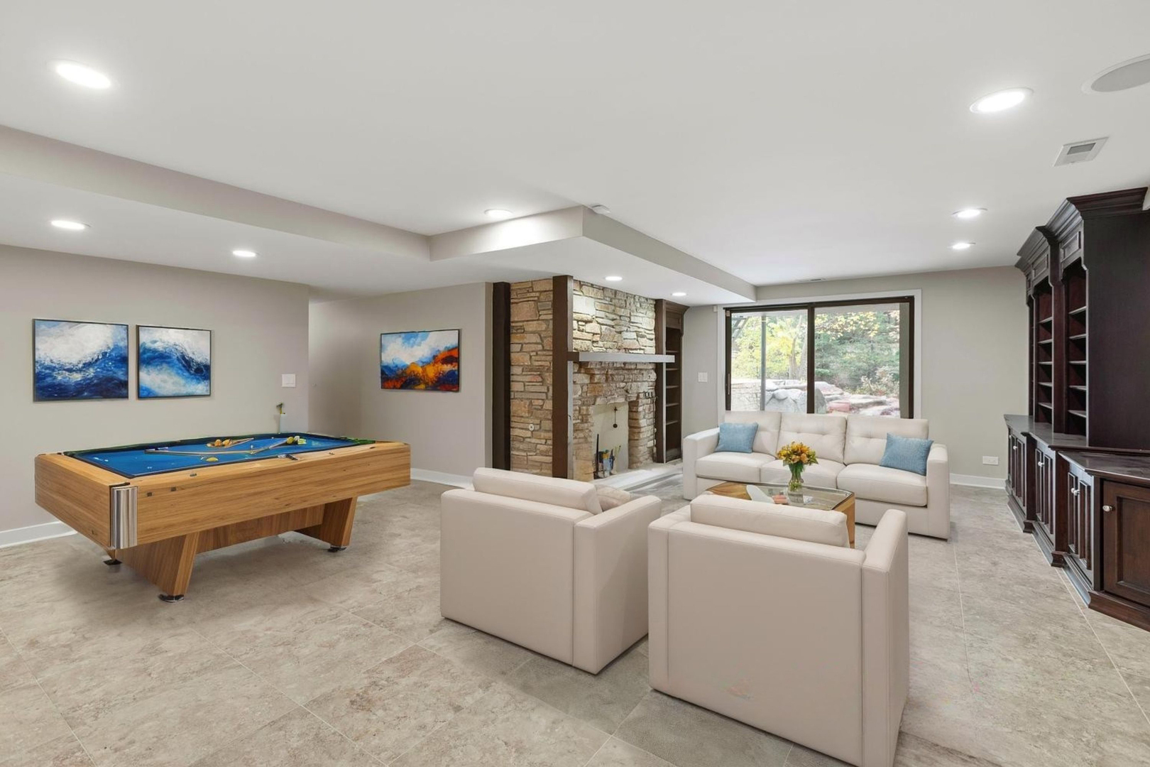 12 Rock Ridge Lane Barrington Hills, IL 60010 - Photo 34 of 52 a living room with furniture a flat screen tv and a floor to ceiling window