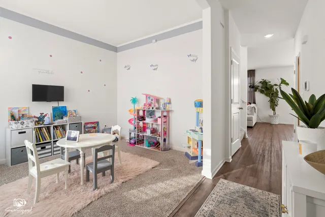 a view of a workspace with furniture and wooden floor