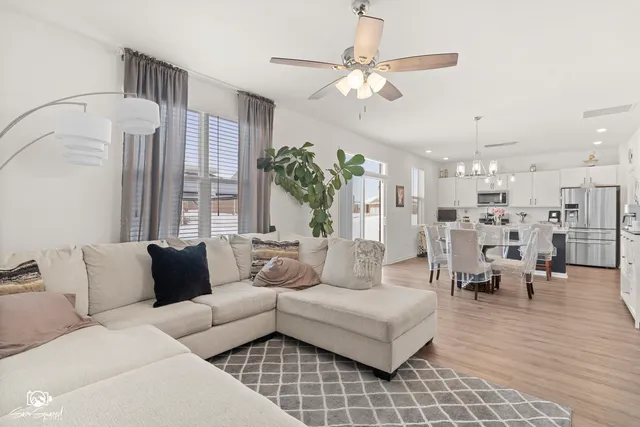a living room with furniture and a chandelier