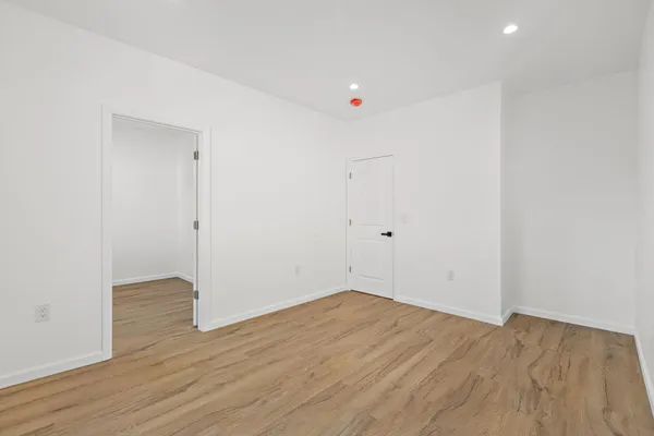 an empty room with wooden floor