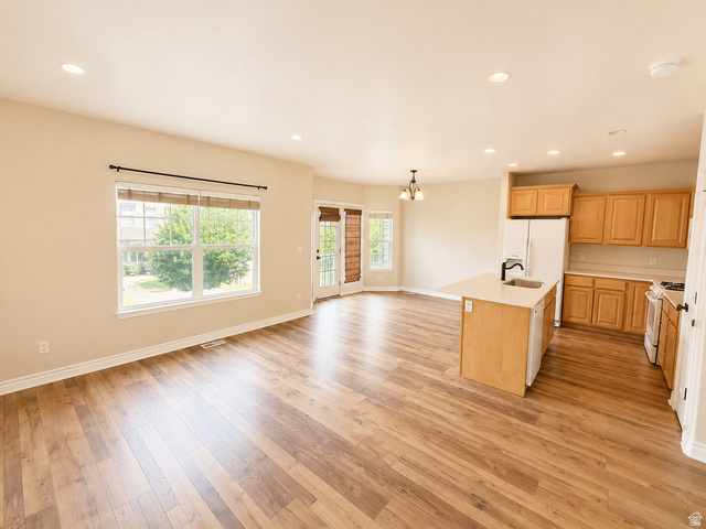 14767 Invergarry Court Draper, UT 84020 - Photo 4 of 18 Expansive open-concept living area featuring wood-finish flooring, recessed lighting, and a kitchen island with an integrated sink