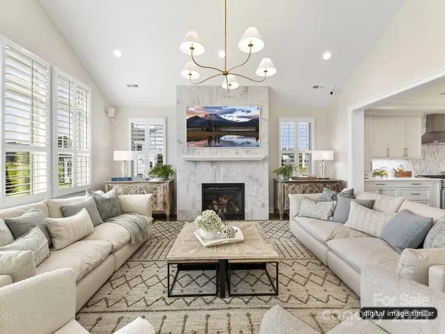 a living room with furniture a fireplace and a flat screen tv