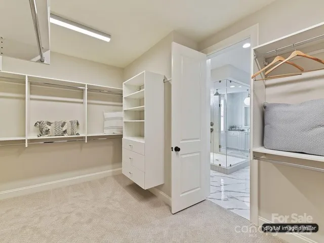 a view of a hallway with wooden floor windows