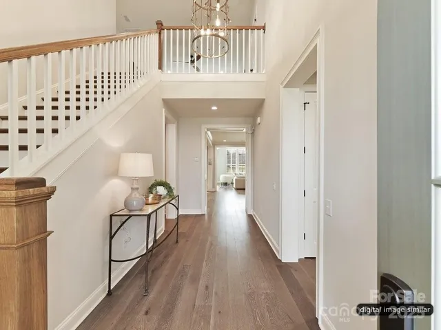 a view of a bedroom with furniture and wooden floor