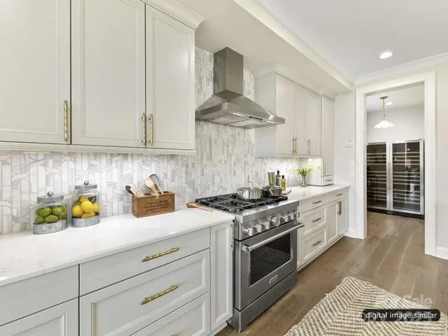 a kitchen with stainless steel appliances granite countertop a sink stove and cabinets