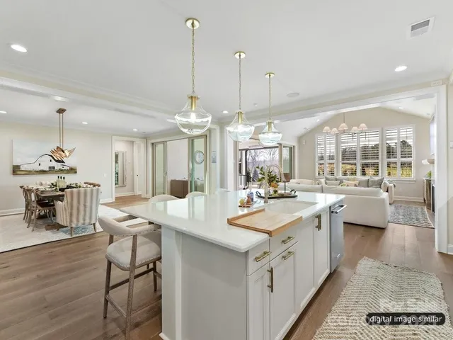 a kitchen with a sink and chairs