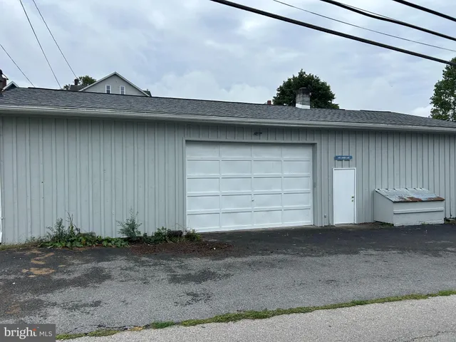 a side view of a house with a yard and garage