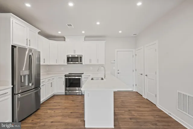 a kitchen with appliances and cabinets