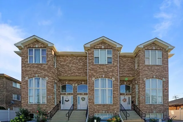 a front view of a house with large windows