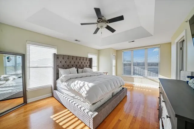a bedroom with a bed and wooden floor