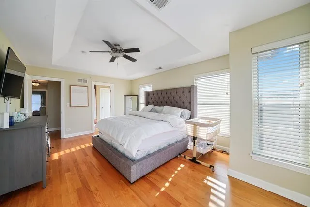 a bedroom with a bed and a chandelier