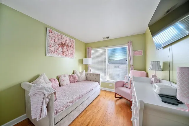 a bedroom with furniture and a large window