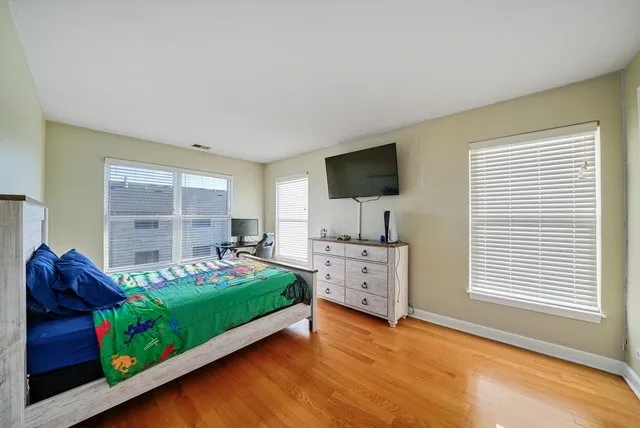 a bedroom with bed and a flat screen tv