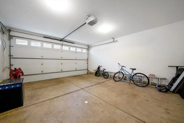 a view of a garage with rack and bicycle