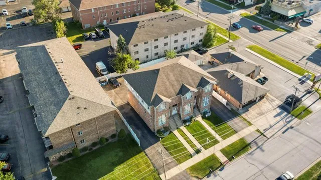 an aerial view of a house with a garden and trees