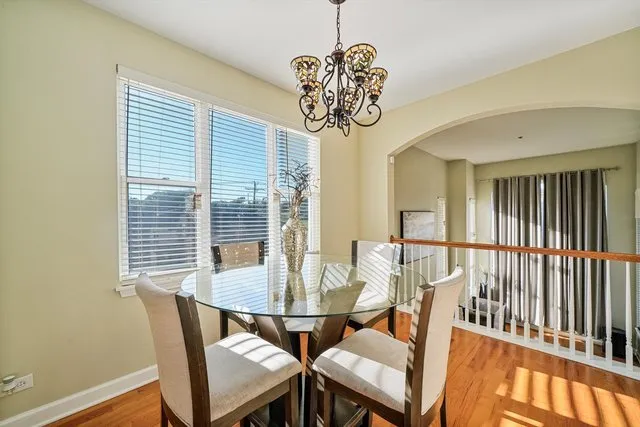 a view of a dining room with furniture wooden floor and chandelier