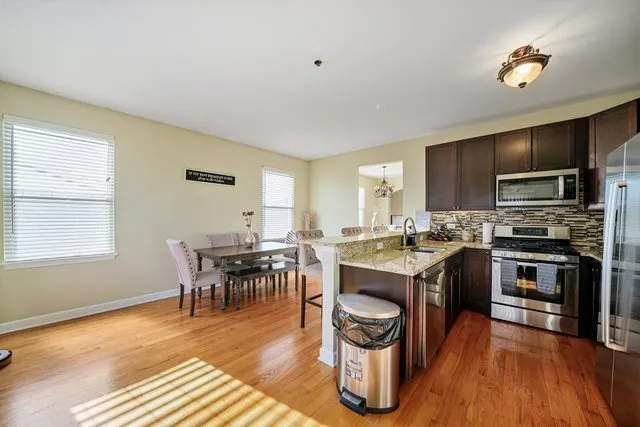 a view of kitchen with sink and wooden floor