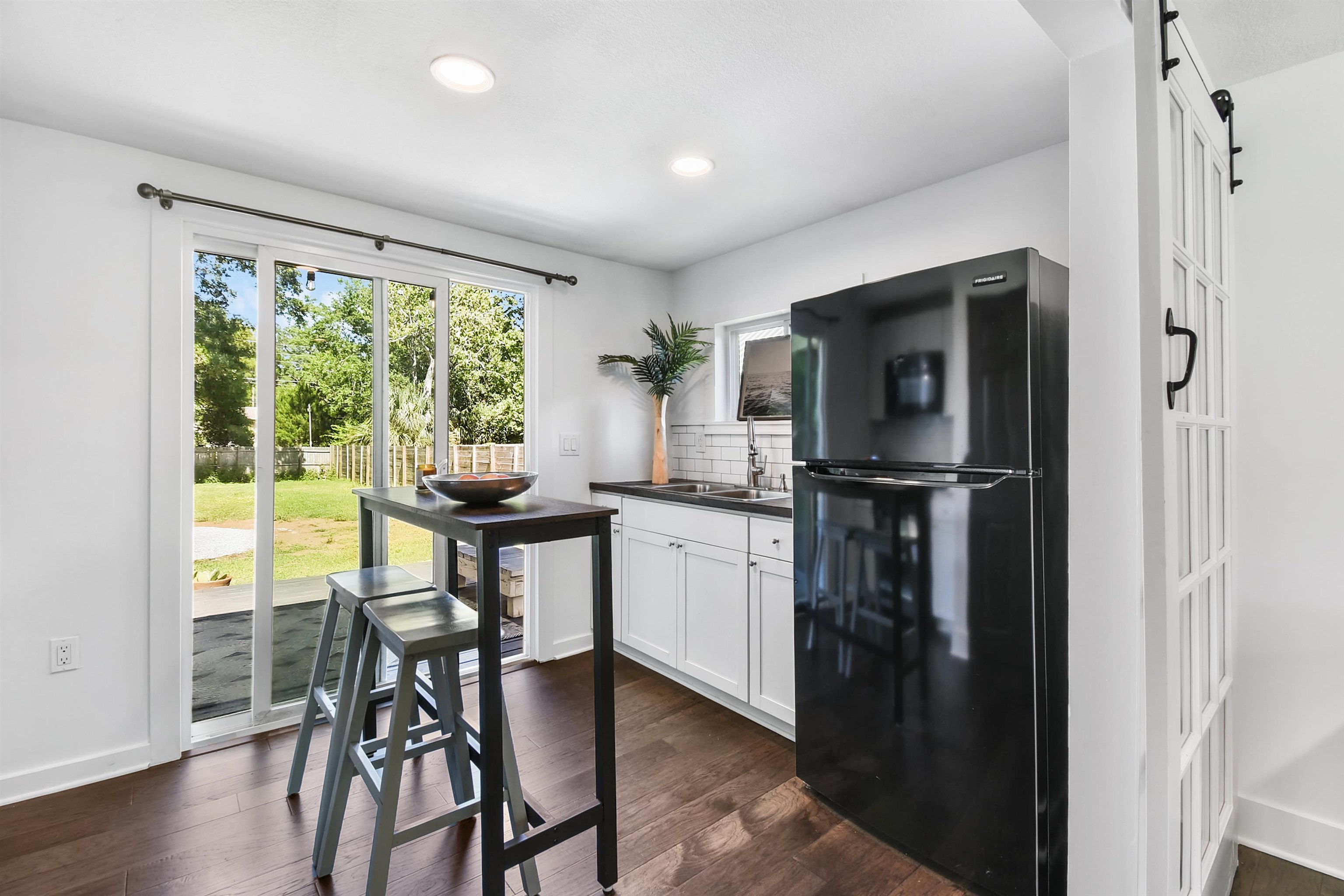 207 Spring Street St. Augustine, FL 32084 - Photo 19 of 32 a kitchen with dining table and wooden floor