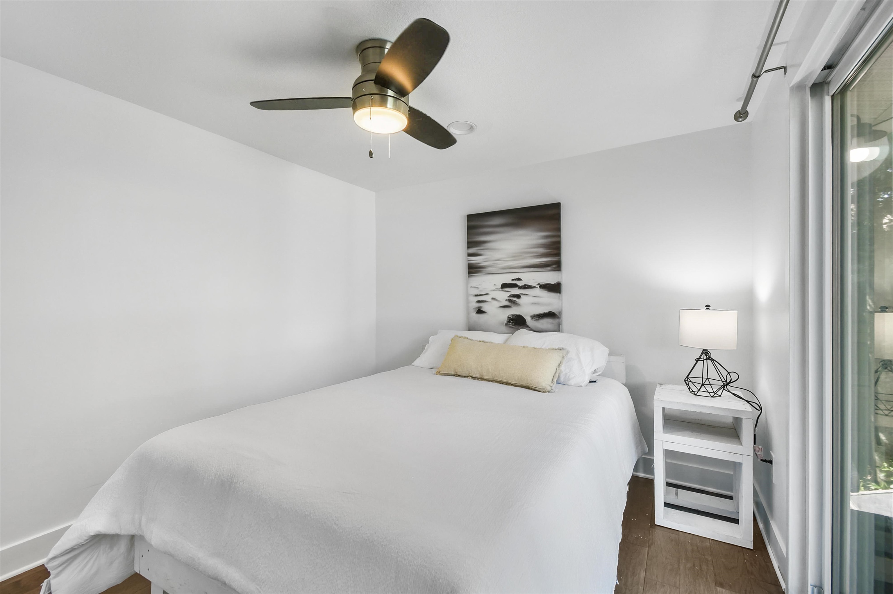 207 Spring Street St. Augustine, FL 32084 - Photo 25 of 32 a bedroom with a bed and a chandelier