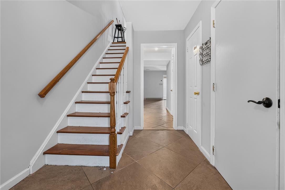 1097 Barnside Road Allentown, PA 18103 - Photo 2 of 22 A welcoming entryway features durable tile flooring and classic wood-tread stairs.