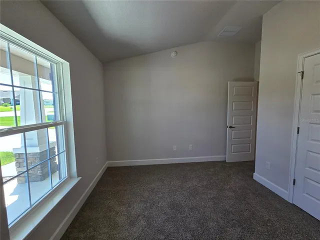 a kitchen with stainless steel appliances granite countertop a stove a sink a refrigerator and white cabinets