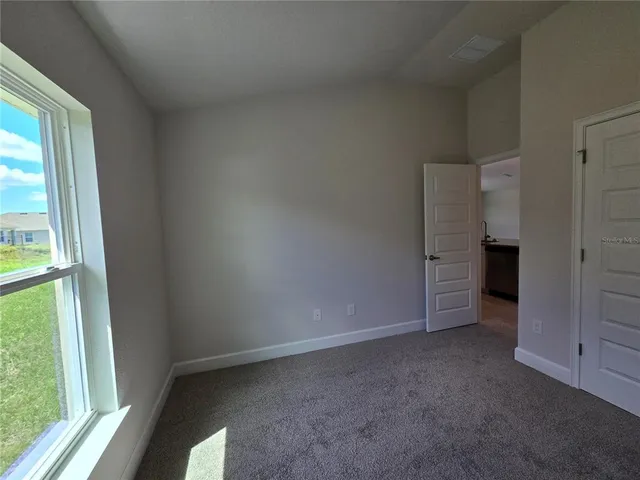 a view of a big room with a kitchen