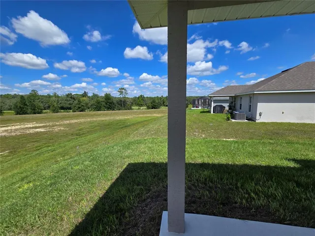 an aerial view of residential houses with outdoor space and parking