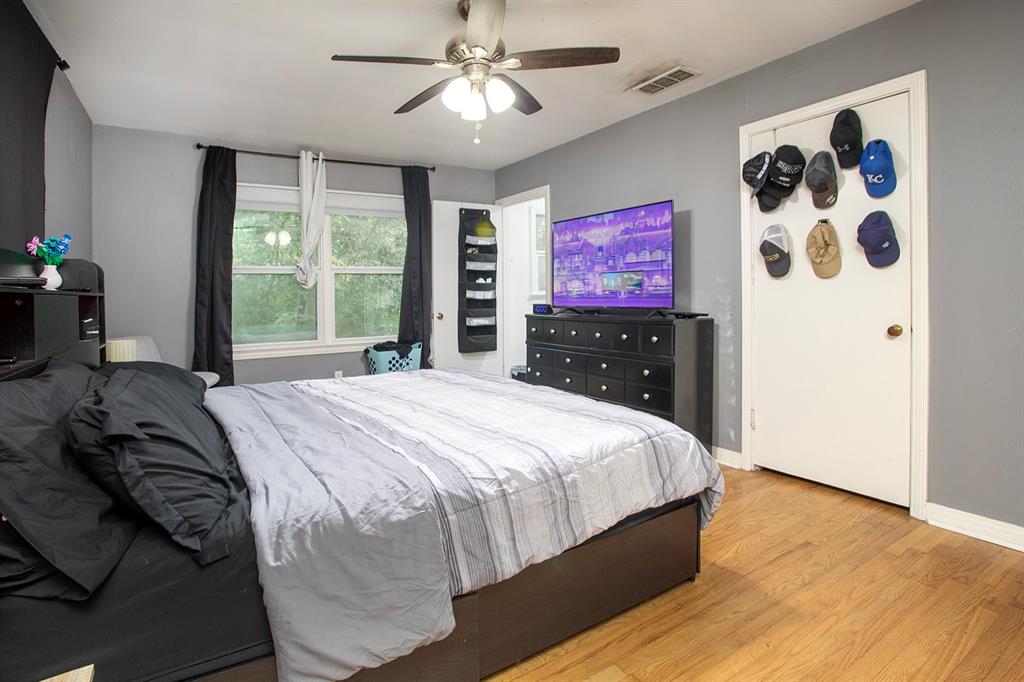 2414 South Martin Street Kilgore, TX 75662 - Photo 16 of 38 a bedroom with a bed and a painting on the wall