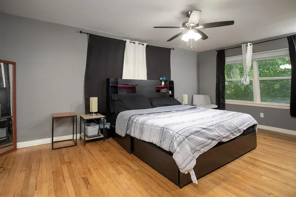 a bedroom with a bed and a window