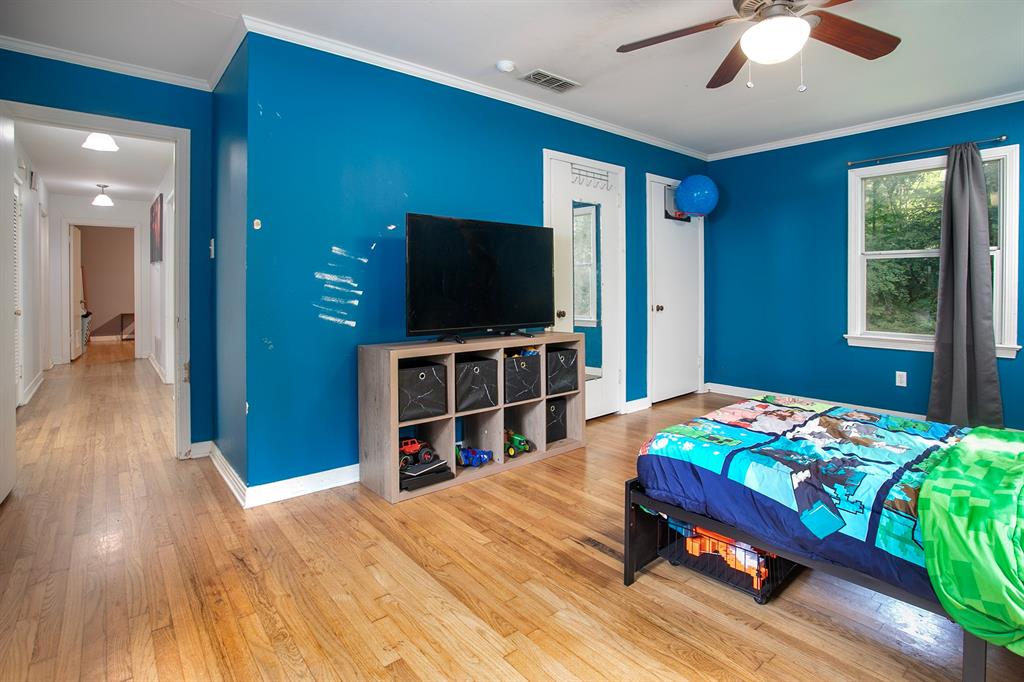 2414 South Martin Street Kilgore, TX 75662 - Photo 20 of 38 a bedroom with a bed and a flat screen tv