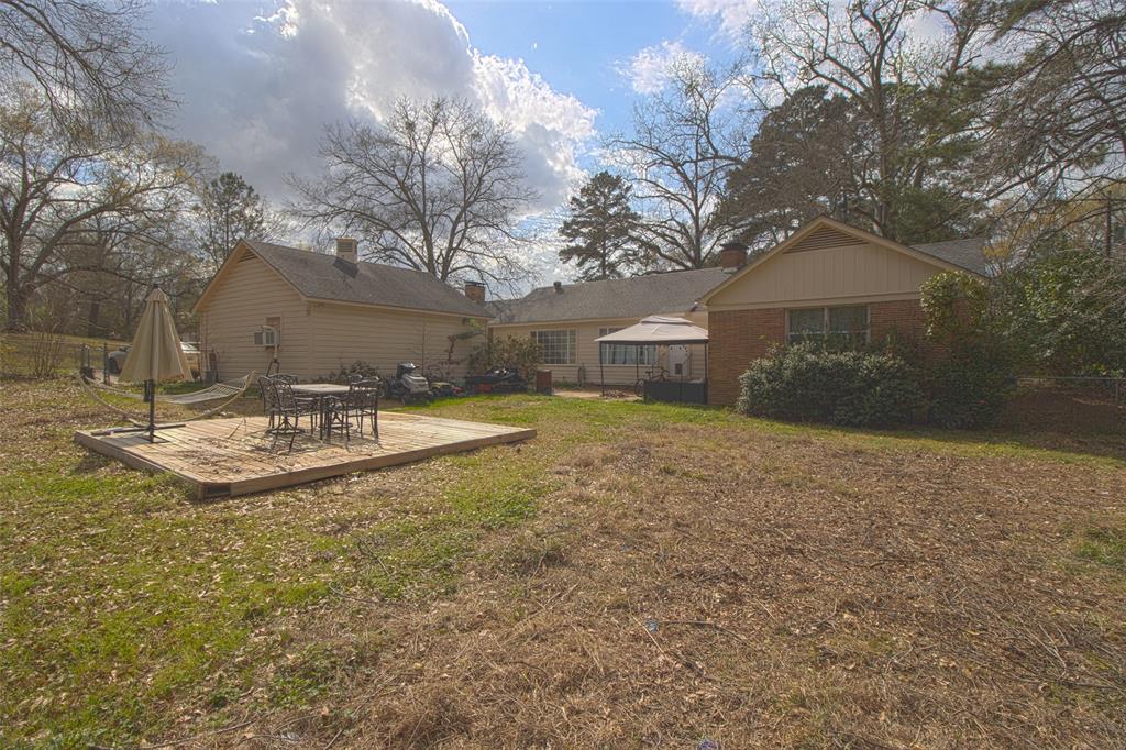 2414 South Martin Street Kilgore, TX 75662 - Photo 27 of 38 a view of a white house with a yard and large tree