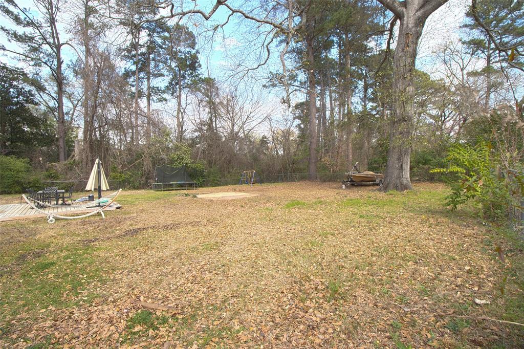 2414 South Martin Street Kilgore, TX 75662 - Photo 31 of 38 a view of a swimming pool with a yard