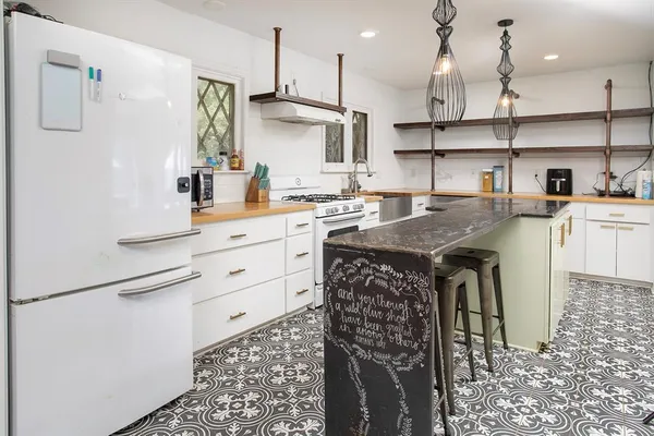 a kitchen with a sink cabinets and window