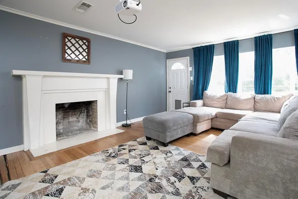 a living room with furniture and a fireplace