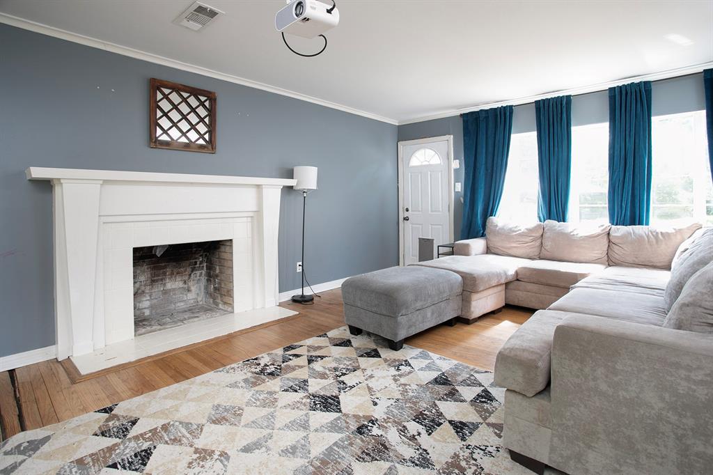 2414 South Martin Street Kilgore, TX 75662 - Photo 8 of 38 a bedroom with a bed and a couch