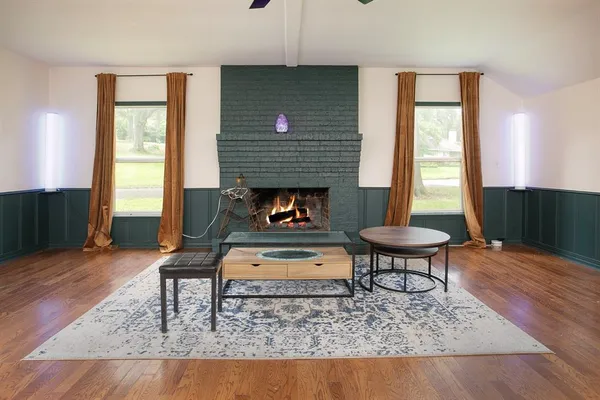 a view of room with wooden floor and furniture