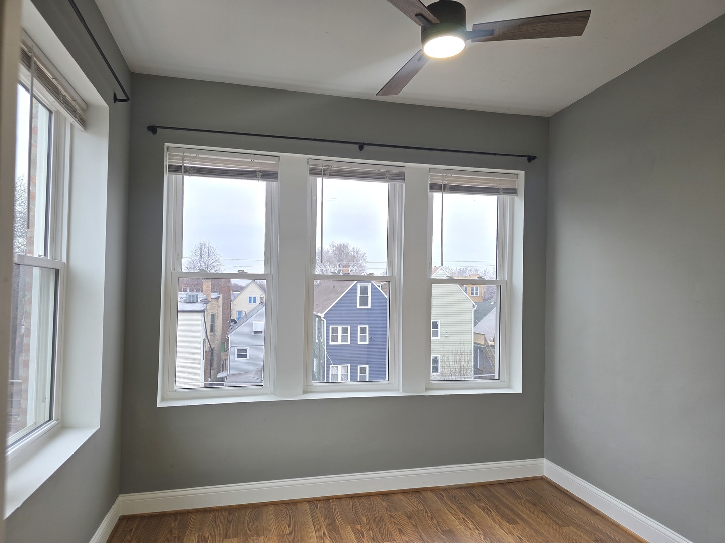 3507 West Belden Avenue, Unit 3 Chicago, IL 60647 - Photo 11 of 15 a view of a livingroom with wooden floor and windows