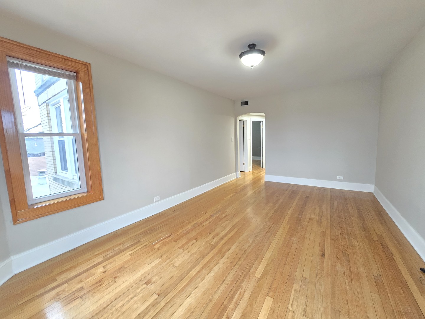 3507 West Belden Avenue, Unit 3 Chicago, IL 60647 - Photo 3 of 15 a view of an empty room and window