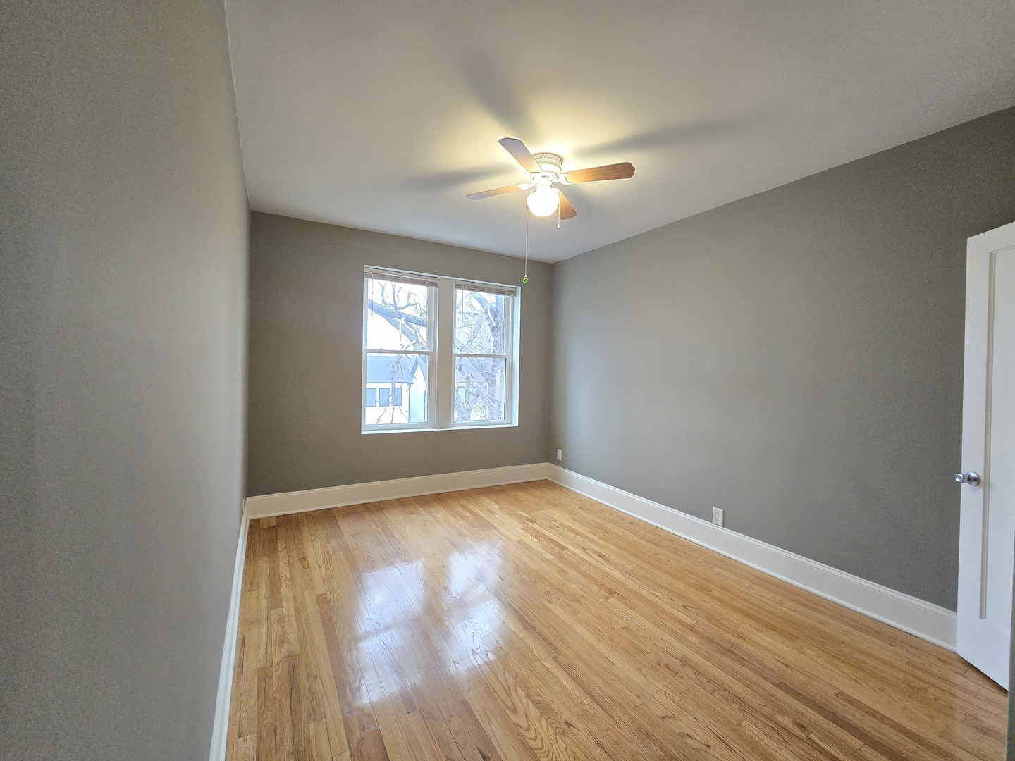 3507 West Belden Avenue, Unit 3 Chicago, IL 60647 - Photo 9 of 15 wooden floor in an empty room with a window