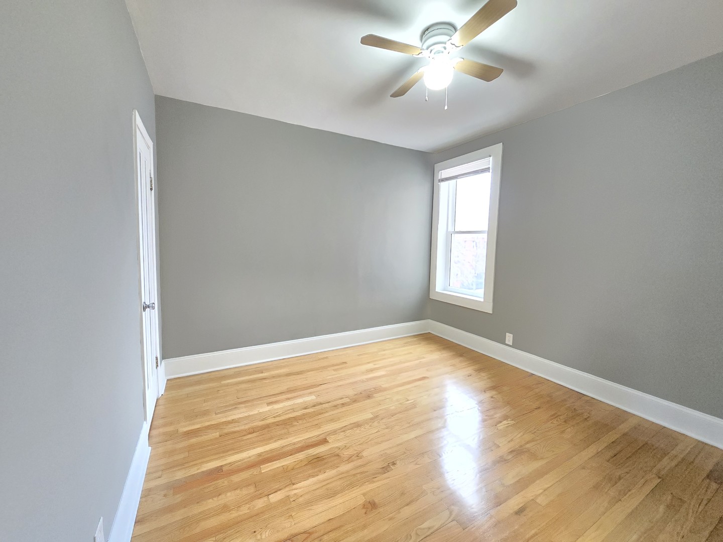 3507 West Belden Avenue, Unit 3 Chicago, IL 60647 - Photo 10 of 15 a view of an empty room with window and a chandelier fan