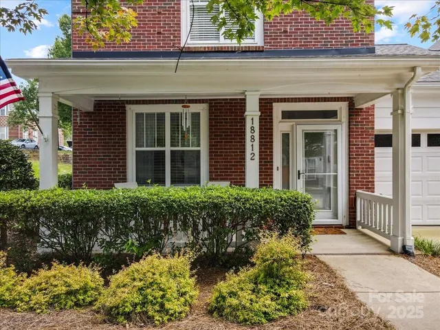front view of a brick house with a large window