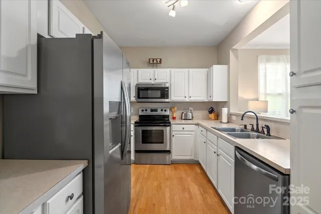 a kitchen with a sink a stove and refrigerator