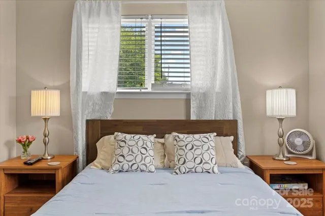 a bedroom with a bed and a window